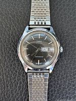 Full view of Timex automatic wristwatch showing case, bracelet, dial, day/date