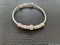 Full view of 999 silver bangle bracelet with bead spacers
