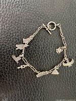 Full view of bracelet showing all seven charms and toggle clasp