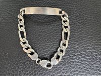 Full view of sterling silver ID bracelet showing curb links and ID plate