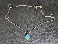 Full view of silver chain and pendant