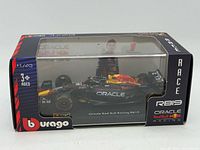 Front and side view of sealed Bburago RB19 die-cast model car inside box