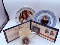 Group shot showing both plates, mug, and open coin folder