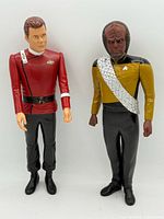 Both vinyl figures standing side by side