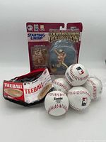 Figure in blister card and bag of baseballs grouped together