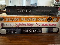 Spine view of the four stacked paperbacks