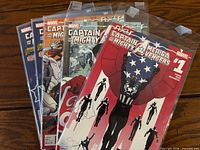 All five bagged Captain America & The Mighty Avengers comic books fanned out