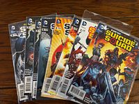 Front view showing all eight New Suicide Squad issues in protective bags
