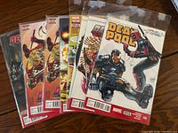 Seven bagged Deadpool comics fanned out