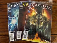 Front covers of three Gotham by Midnight comics (#1, #2, #4) in bags