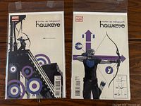 Front covers of two bagged Hawkeye comic books issues 1 and 2