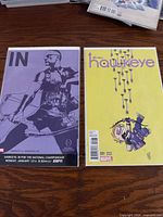 Front covers of both Hawkeye comic books in protective sleeves