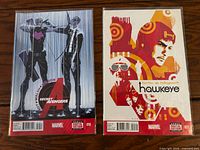 Front covers of Secret Avengers 010 and Hawkeye 021 in sleeves