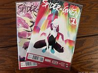 Front covers of two bagged Spider-Gwen comic books, issues 1 and 2