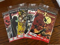 Front view of five bagged comic books fanned out