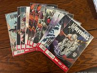 All 12 Wolverines comic books fanned out showing bagged condition
