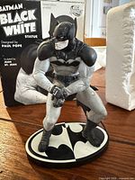 Front view of Batman Black & White statue with box behind