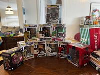 Group shot of all boxed figures arranged in pyramid formation, showing variety and box fronts