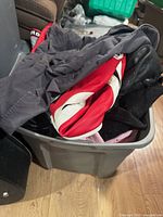 Bin containing multiple jackets and suit pieces