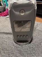 Front view of Apple Power Mac G4 tower showing power button, drive bay covers, ventilation slots