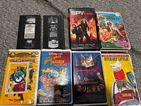 Group shot of all eight VHS tapes showing covers and two loose tapes