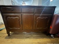 Front view showing drawers, doors, hardware and legs