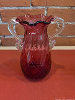 Front view showing cranberry color, clear handles, diamond pattern
