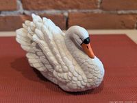 Left front view of ceramic swan showing feather detailing