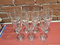 Front view of 11 clear glass champagne flutes
