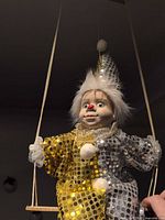 Full view of clown doll hanging from swing
