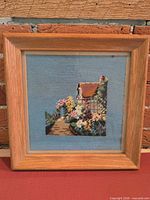 Front view of framed needlepoint showing complete design and frame