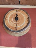 top view of handmade ceramic wall clock showing full face and numerals