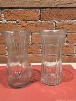 Front view of both clear ribbed vases