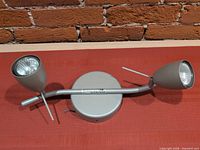 Top view of silver two-head ceiling light showing adjustable heads and base