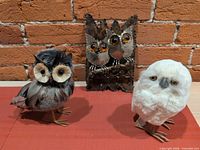 All three owl items: two standing figurines and metal wall holder