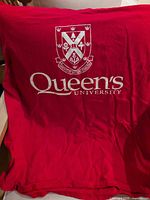 Front of red Queen's University short-sleeve T-shirt with crest and logo