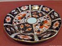 Front view of Royal Crown Derby Imari saucer showing full pattern and gold rim