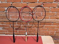 Front view of all three badminton rackets standing upright