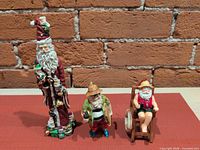 All three Santa figures grouped for scale comparison