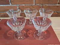 Five clear crystal sherbet glasses grouped on table