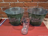 Overall lot: two Steam Whistle buckets and glass boot