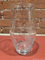 Front view of clear glass vase showing floral etching and shape