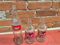 Front view of all three bottles showing labels and shapes