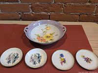 Group shot of one handled bowl and four small dishes