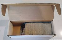 Open cardboard box showing full stack of hockey cards