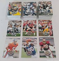 Stacks and sample layout of 1996 Donruss NFL trading cards showing fronts with team logos and player images
