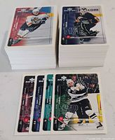 Two stacks of 1999-00 Upper Deck MVP hockey cards with several cards fanned in foreground