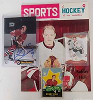 Group shot of all four Bobby Hull items: magazine and three trading cards
