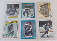 Front view of all six Darryl Sittler cards in top-loaders