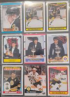 Nine of the twelve Ray Bourque cards arranged in 3×3 grid showing mix of early career Bruins base issues, Norris Trophy winner cards and All-Star card